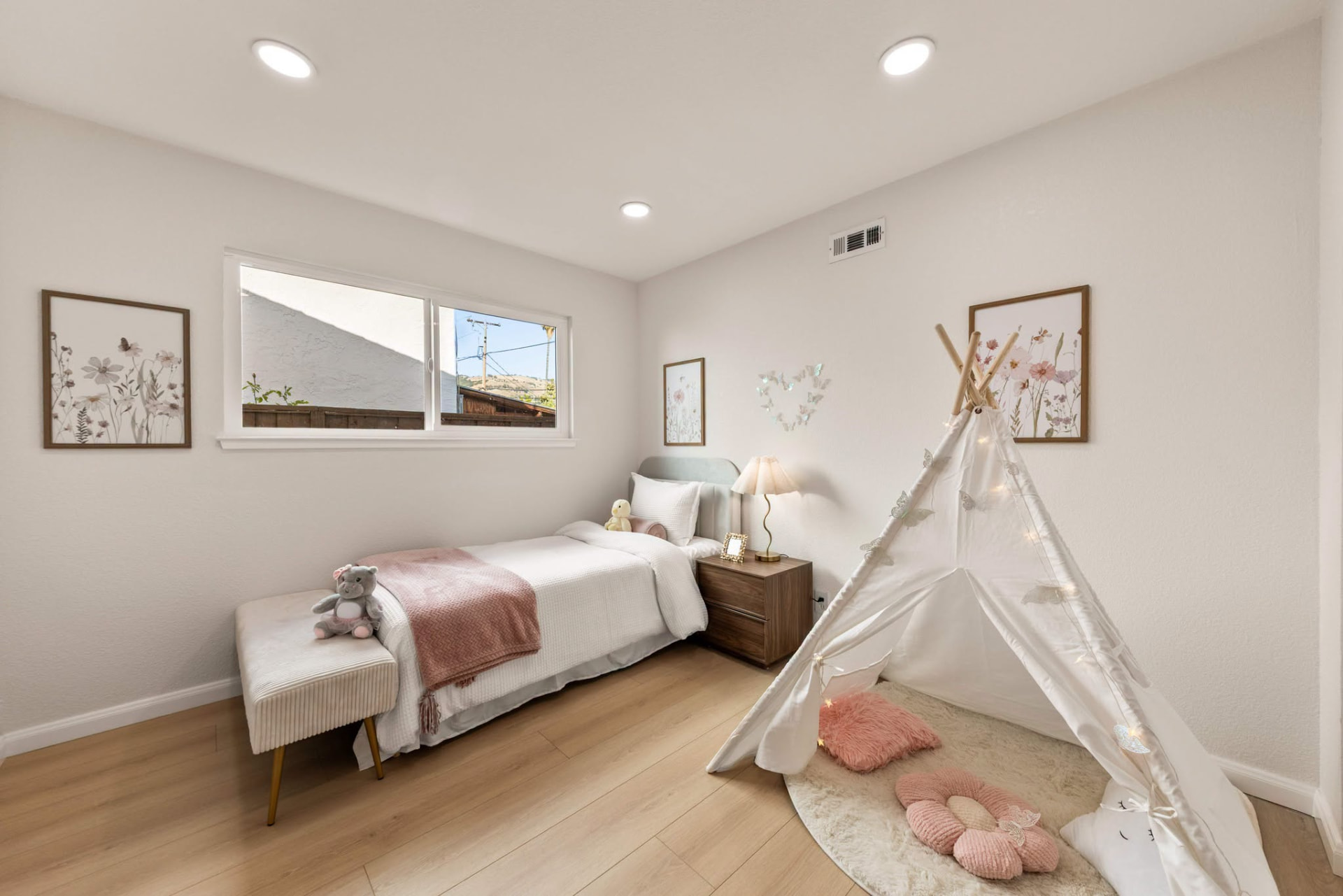 Children's bedroom with teepee, floral art and soft pink accents styled by ONSTAGE